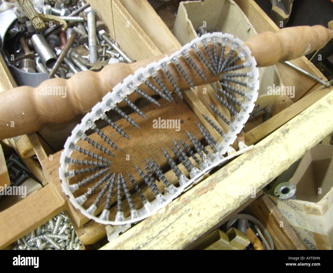 Looped belt of drywall screws resembles caterpillar treads. Stock Photo