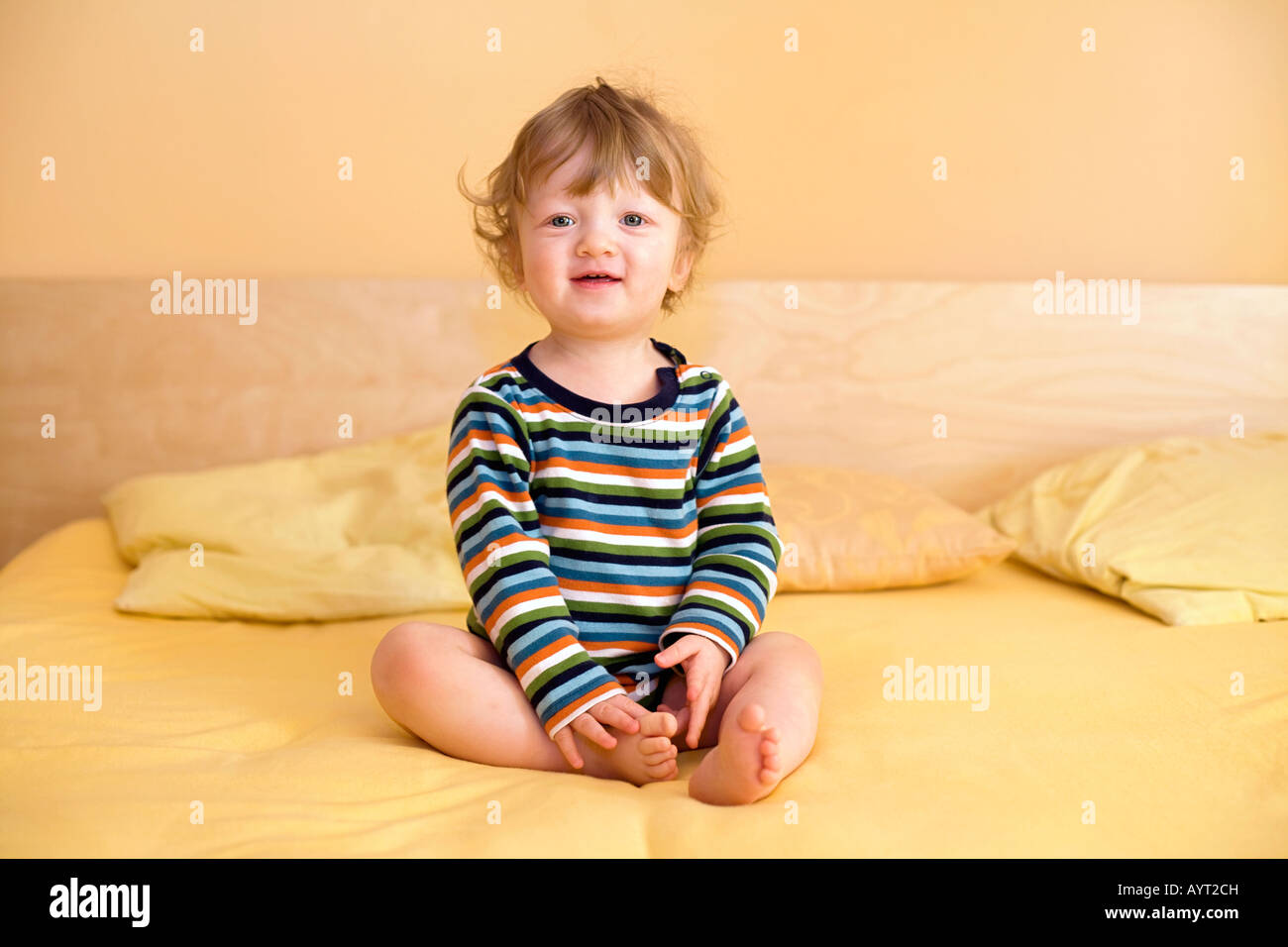 Baby sitting on bed hi-res stock photography and images - Alamy