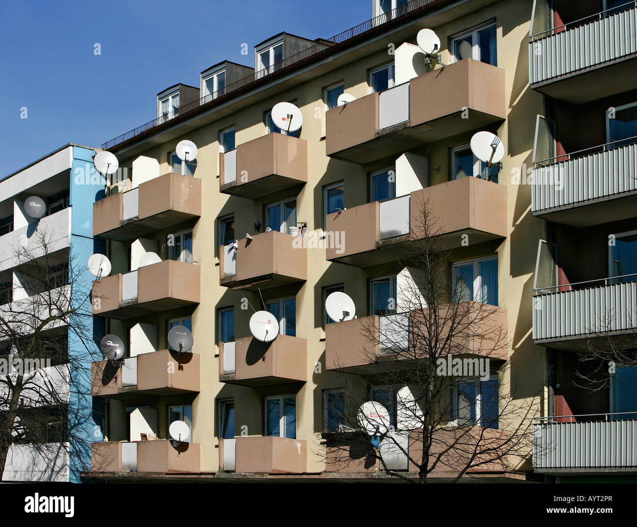 Satellite dishes mounted to the balconies of an apartment building Stock Photo