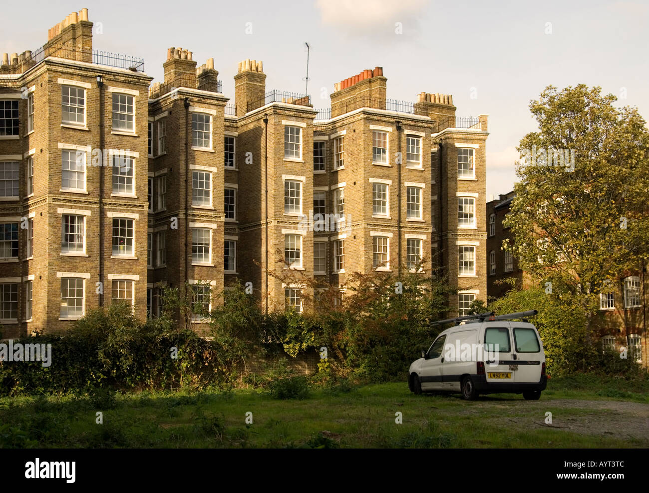 Grade II listed Tower Buildings (1864) and white panel van, Wapping, London, UK. Stock Photo