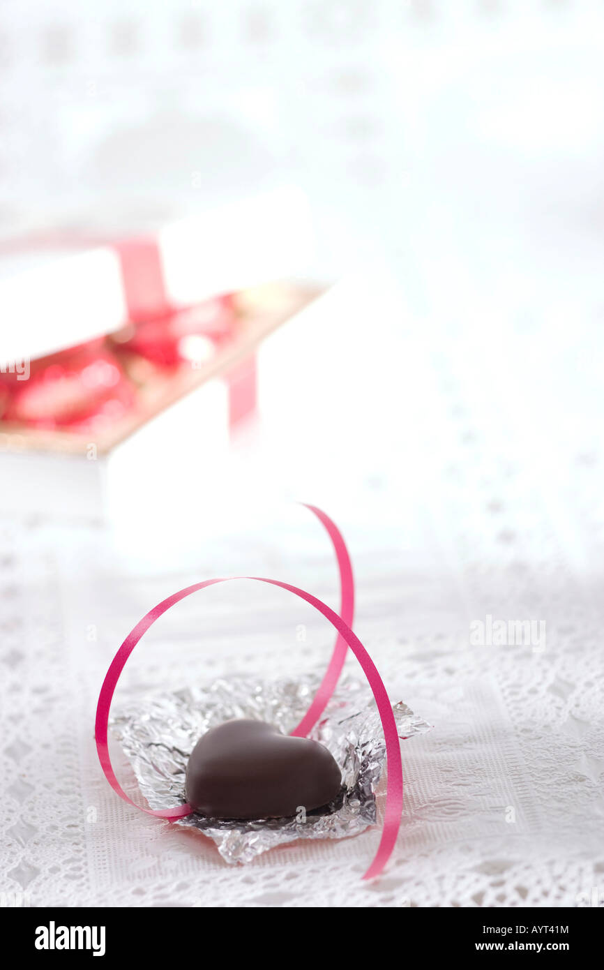 Unwrapped marzipan heart and ribbon Stock Photo