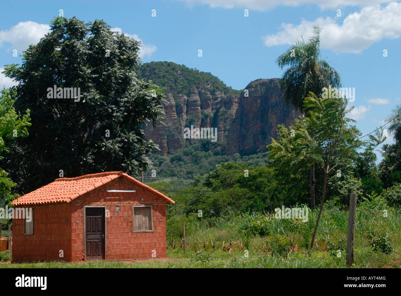 Small unpainted Paraguayan house in front of mountains, Cerro Memby, Paraguay, South America Stock Photo