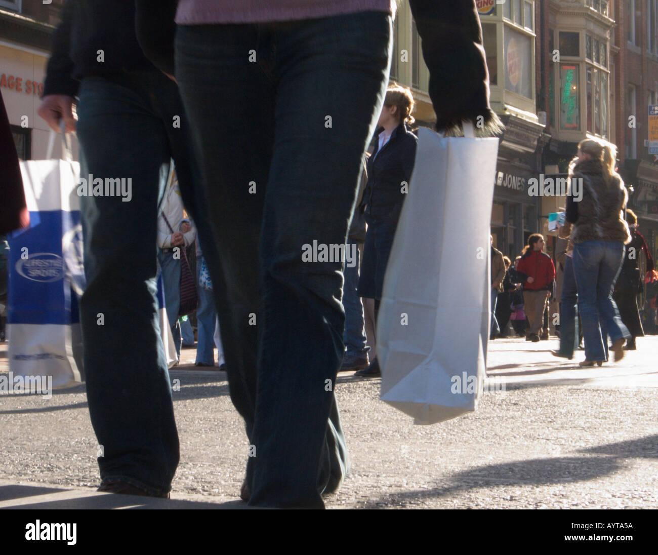 Customers carrying shopping bags in street scene, shopping in Graften