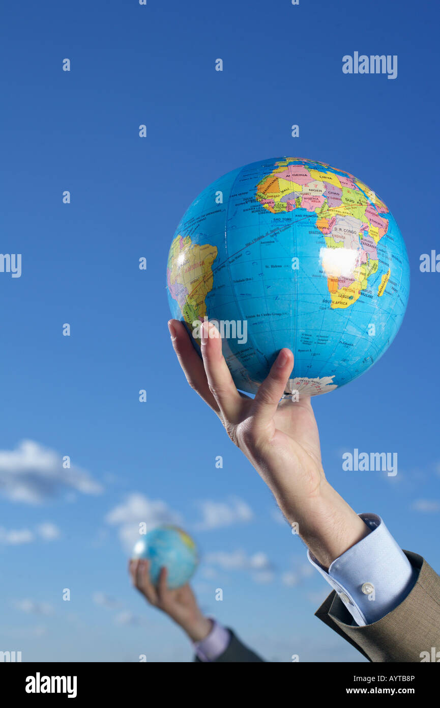 Two people holding up globe hi-res stock photography and images - Alamy