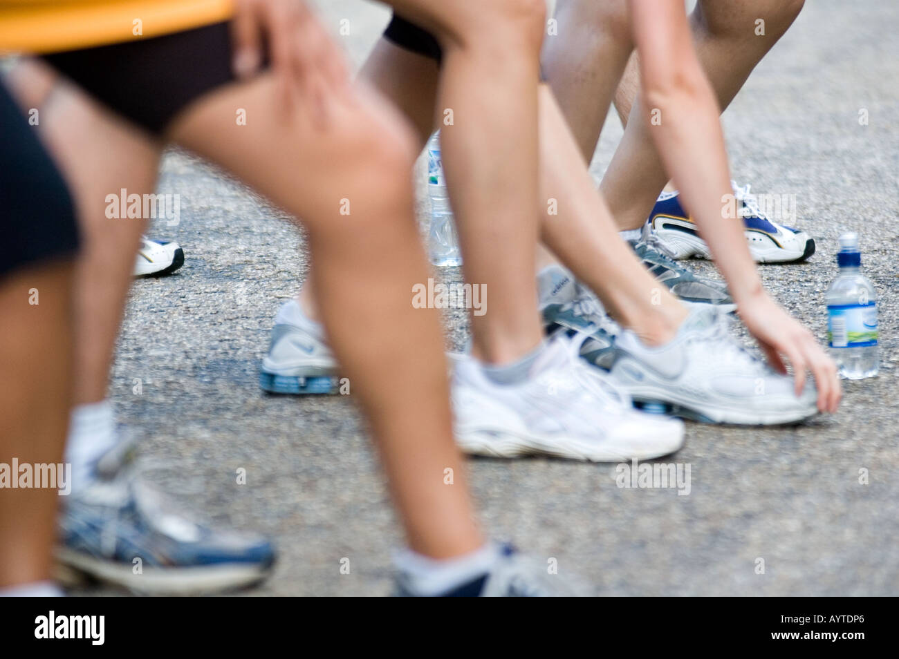 Runners legs and feet while stretching Stock Photo - Alamy
