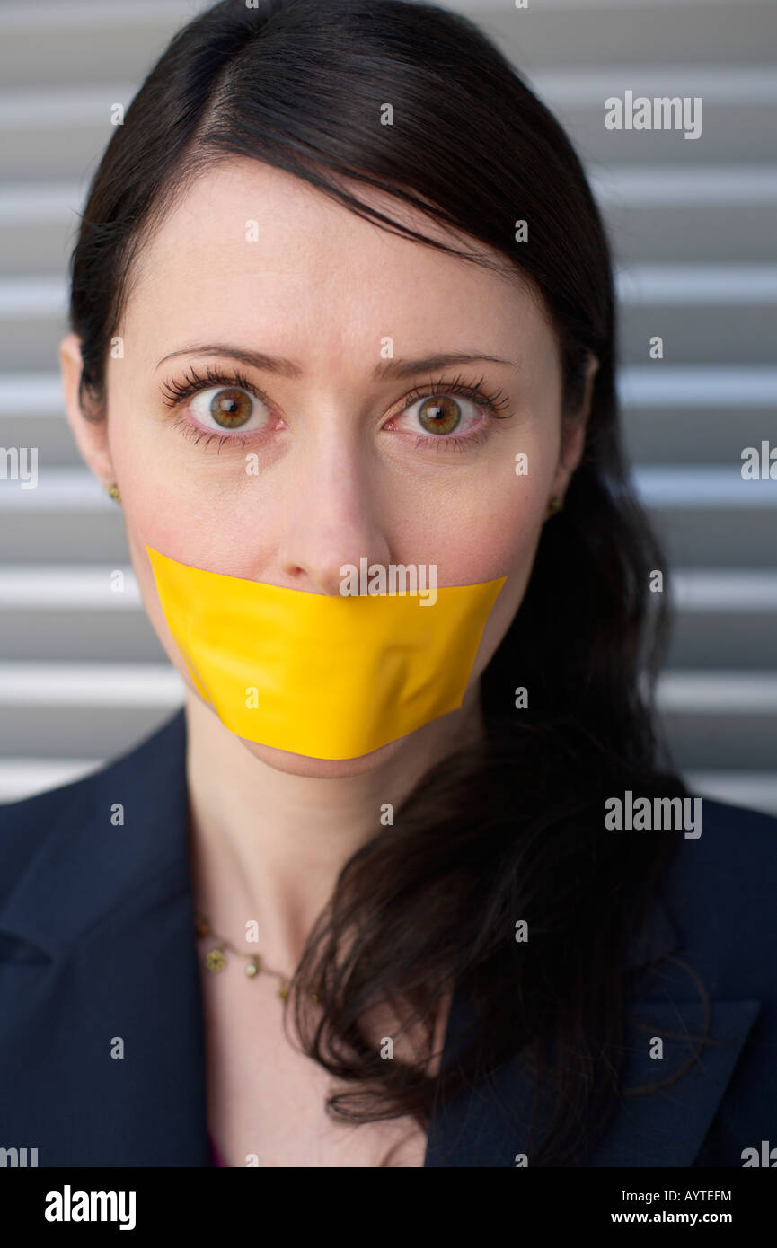 Yellow adhesive tape over businesswoman's mouth Stock Photo Alamy