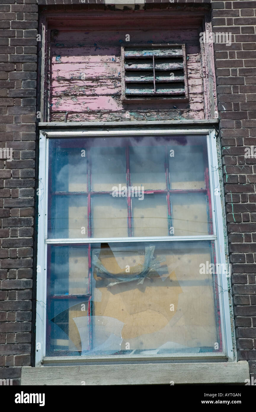 Broken window on derelict building Stock Photo