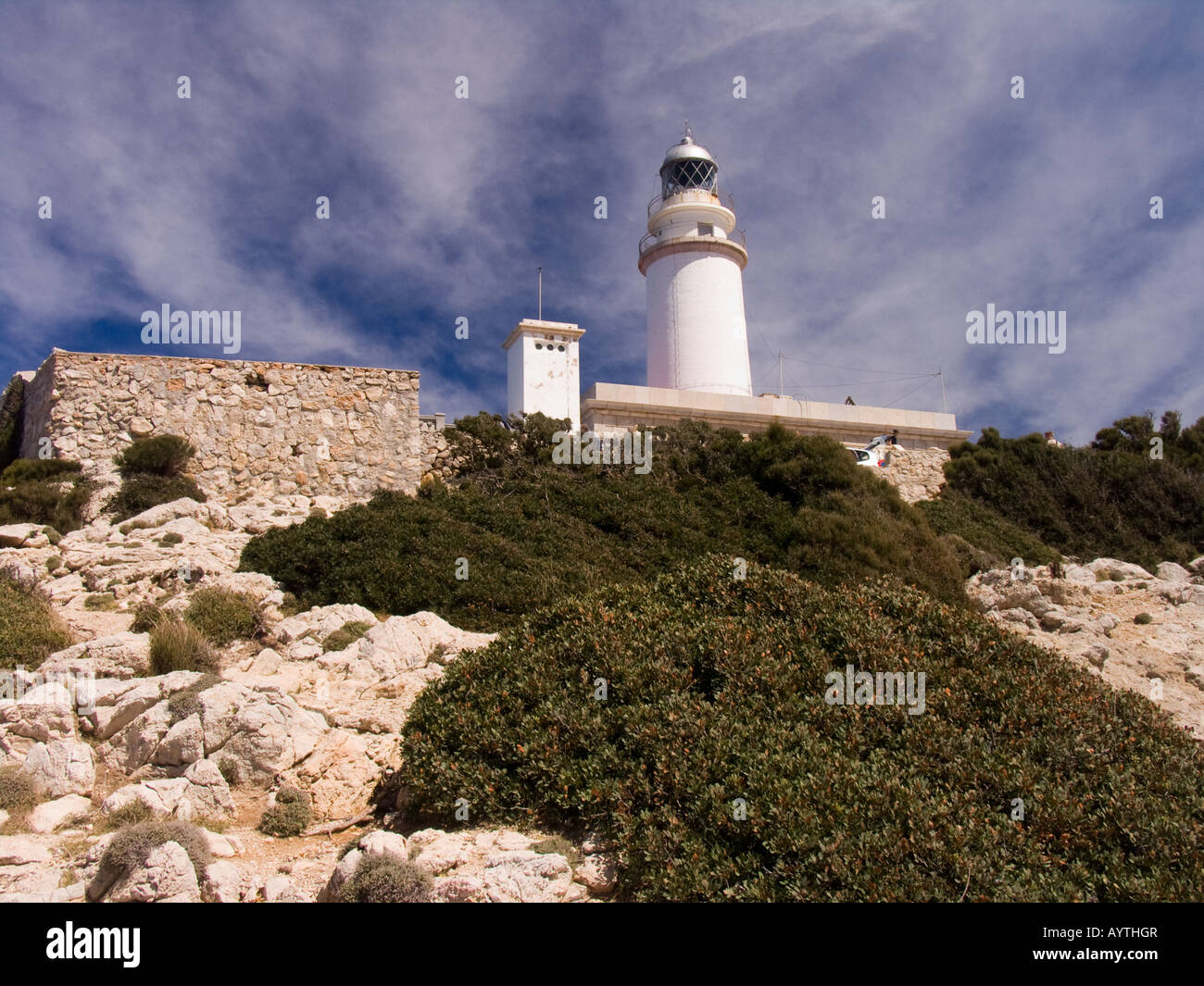 White lighthouse at the point of Cap de Formentor Mallorca with whispy clouds taken with polarising filter Stock Photo