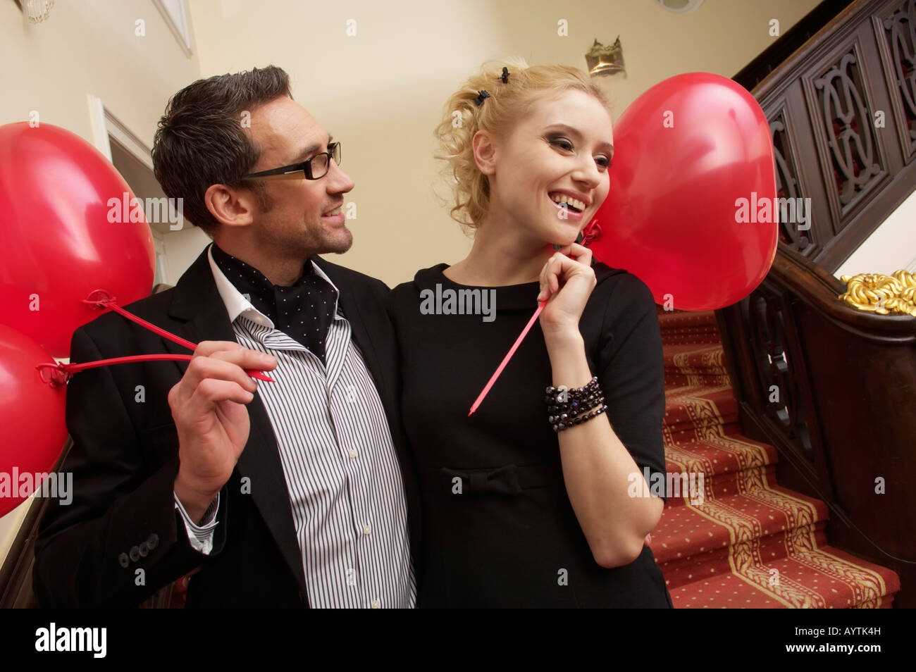 Couple with heart shaped balloons on a stairway Stock Photo - Alamy