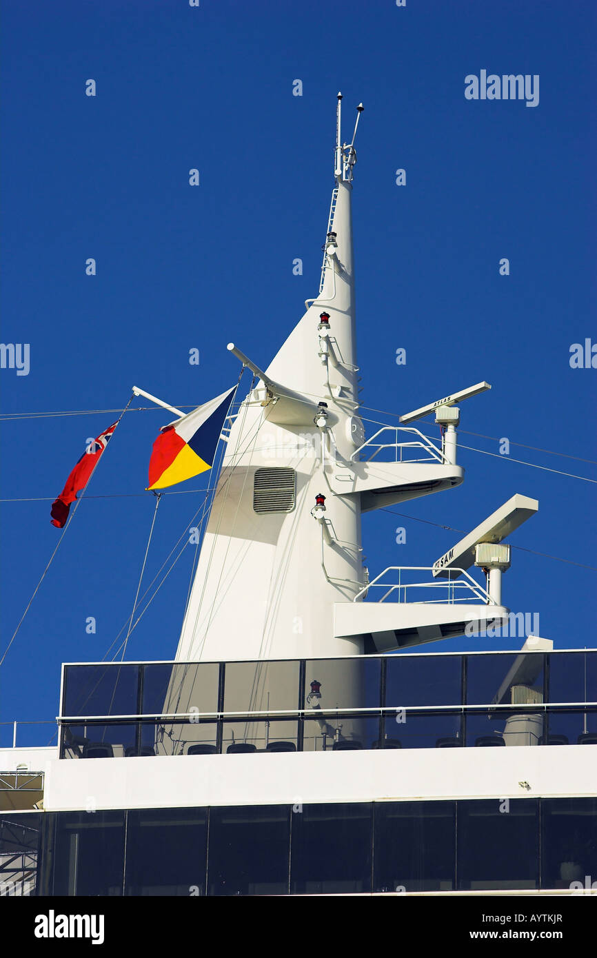 Cruise ship's radar tower with three radars and flying P&O flag and red Ensign with a clear blue sky background Stock Photo