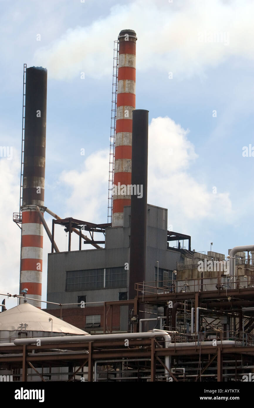 Smokestacks on a factory emit smoke and steam into the sky Stock Photo ...