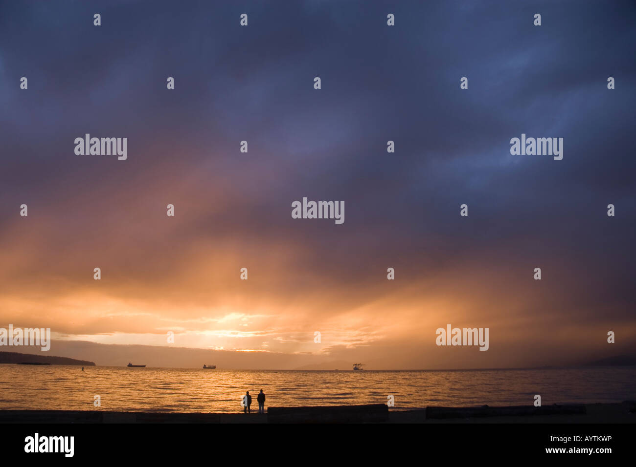 People watch sun set on beach hi-res stock photography and images - Alamy