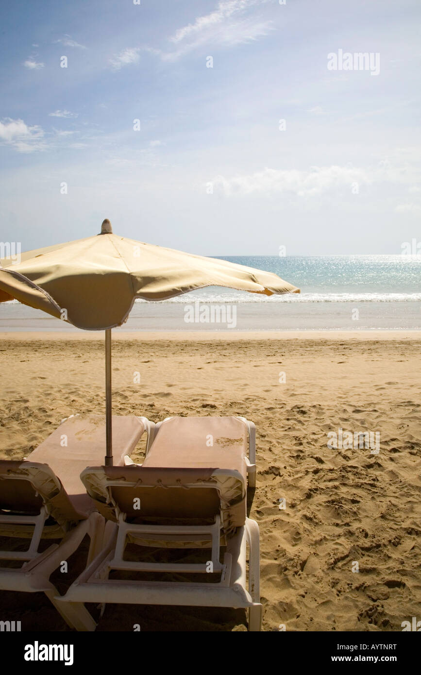 Still Life Of Beach Chair And Sunshade On A Beach With The Sea In