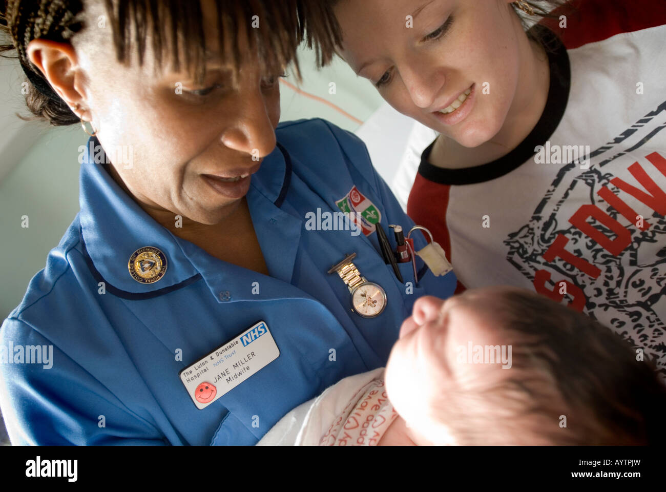 Midwife with new mum and her baby Stock Photo