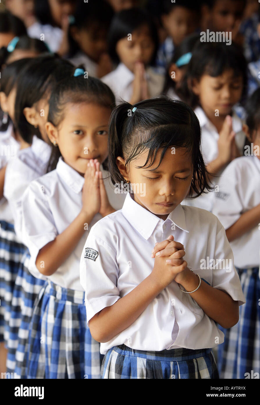 Indonesia: pupils attending christian schoolprayer at the catholic school in Makassar (Ujung Padang) Stock Photo