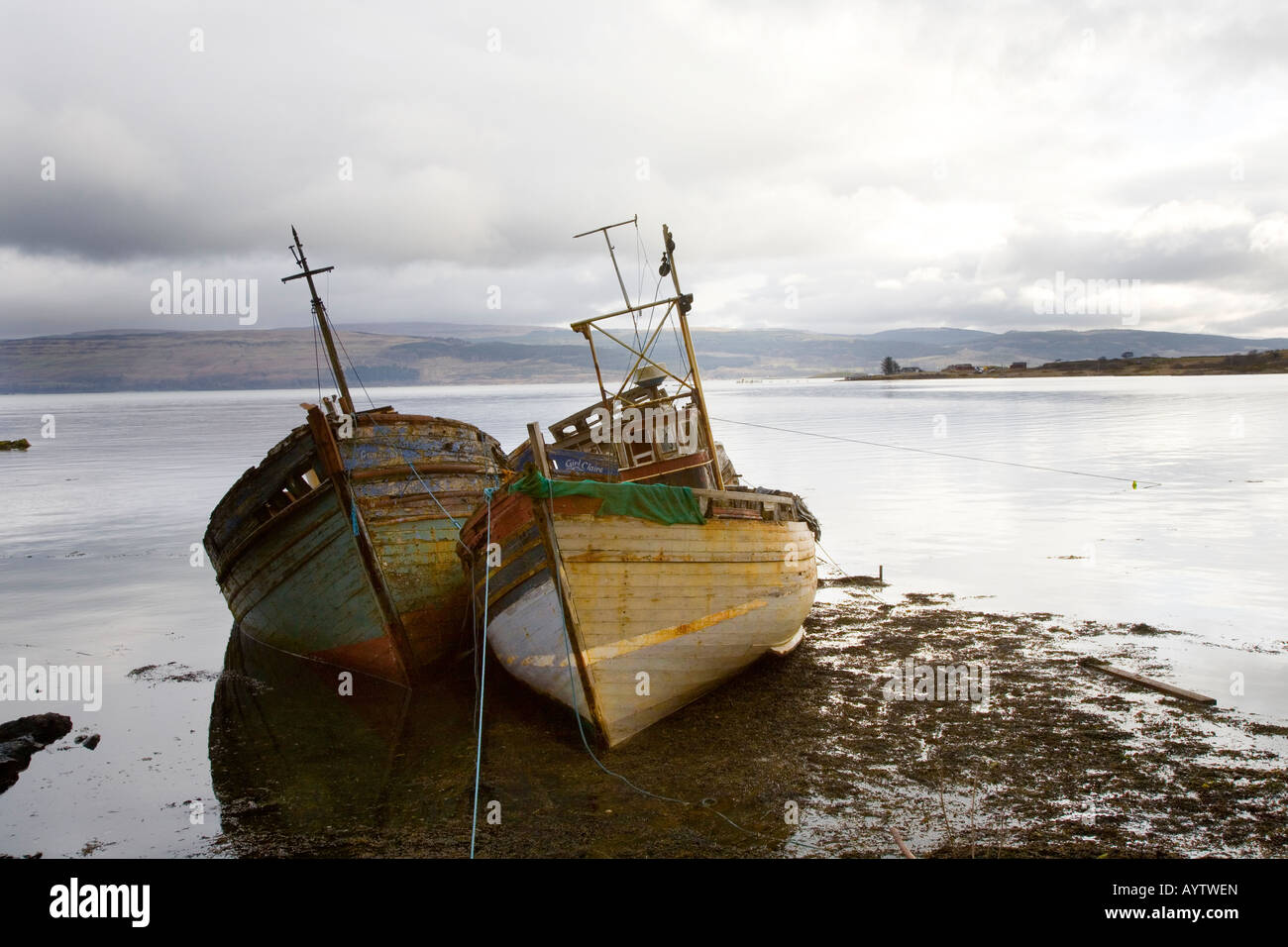 Two beached, Wrecked & Abandoned old wooden fishing boats on the beach at Salen, Isle of Mull, Argyll, Scotland UK Stock Photo
