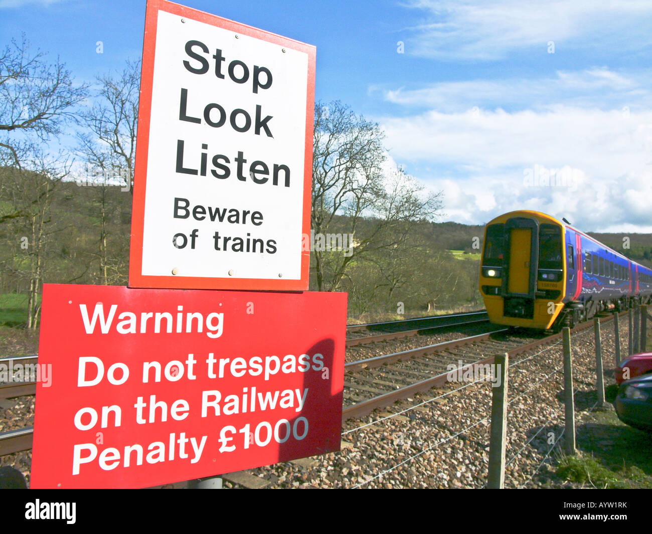 Regional passenger train approaching unmanned level crossing at Claverton Somerset England UK EU Stock Photo
