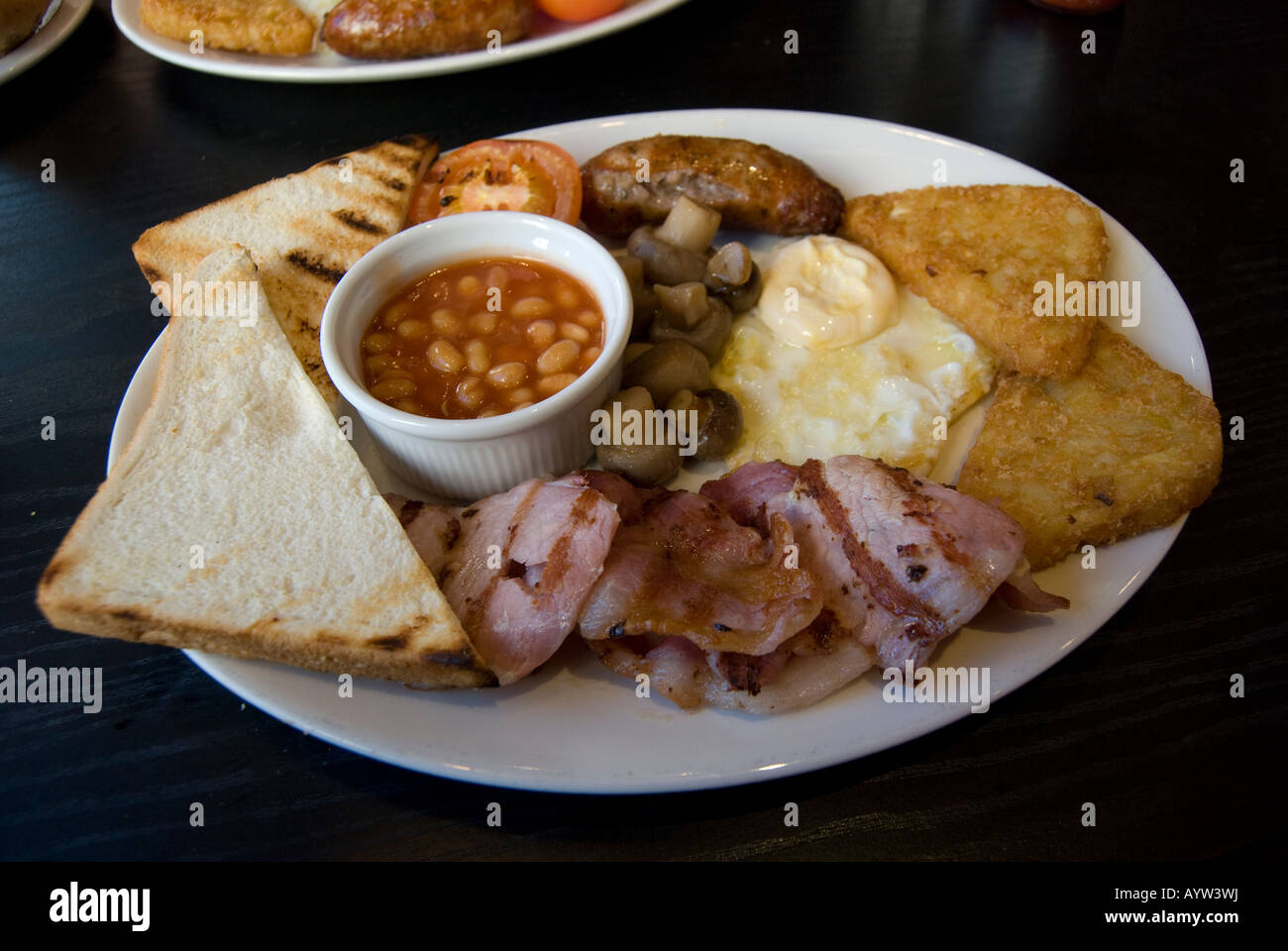A traditional English Breakfast of toast,eggs,potatoes, tomato,baked