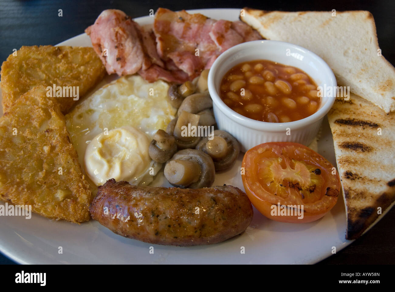 A traditional English Breakfast of toast,eggs,potatoes, tomato,baked