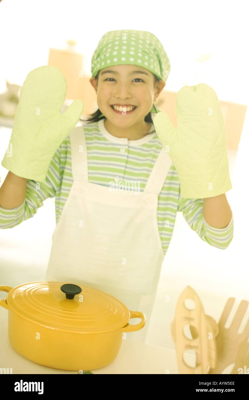 A girl with oven mitten Stock Photo