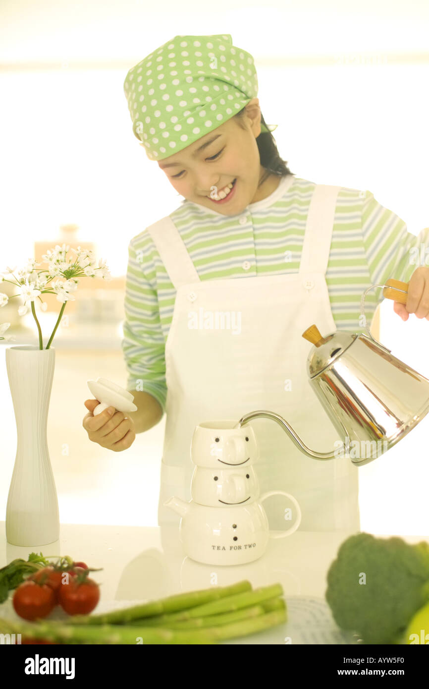 A girl making tea Stock Photo - Alamy