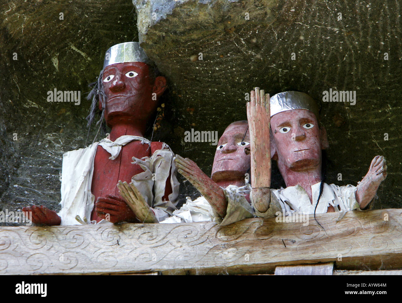 Indonesia: wooden funeral effiges (Tau Tau) at the cliff thombs of Lemo Stock Photo