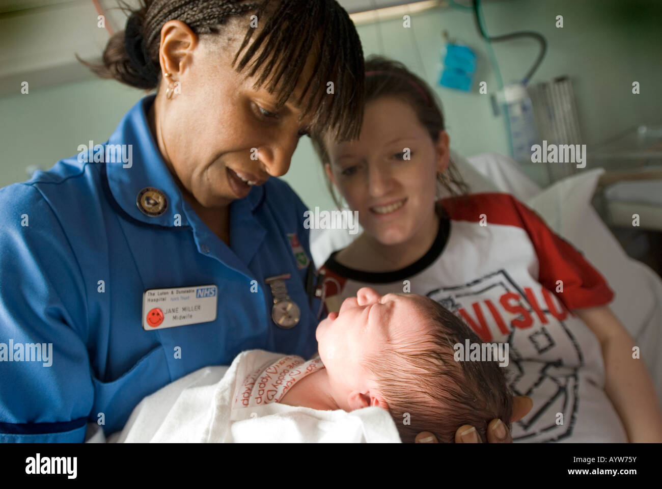 Midwife with new mum and her baby Stock Photo