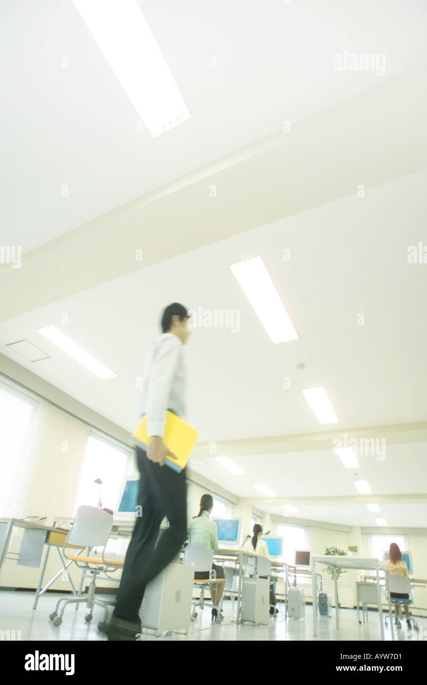 Office worker walking in a sophisticated office Stock Photo