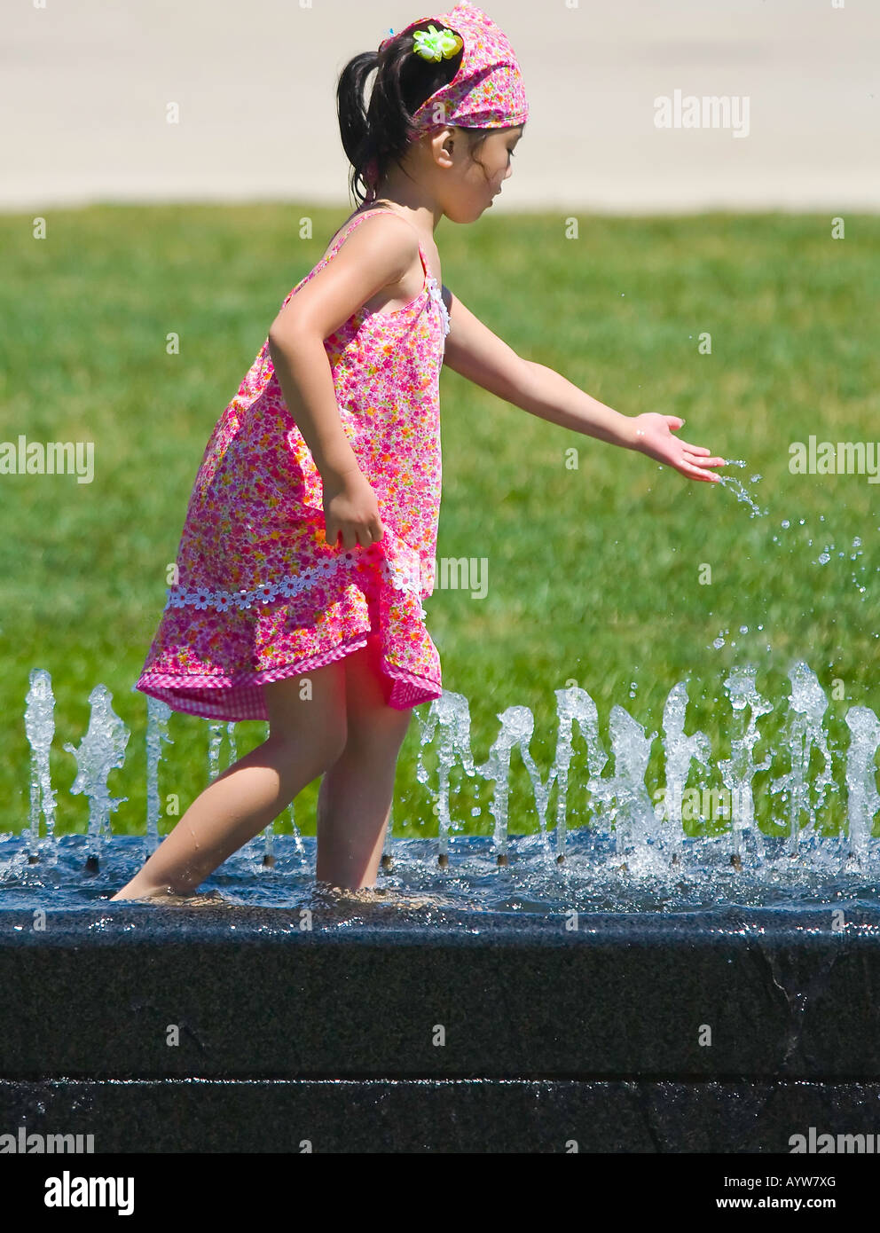 Young Asian girl playing in a fountain Stock Photo - Alamy