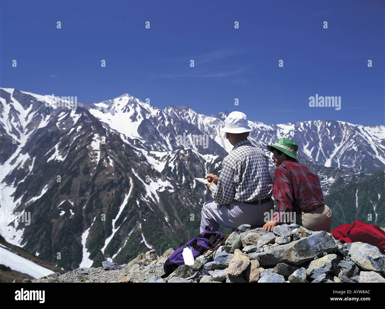 Old couple on the summit of mountain Stock Photo