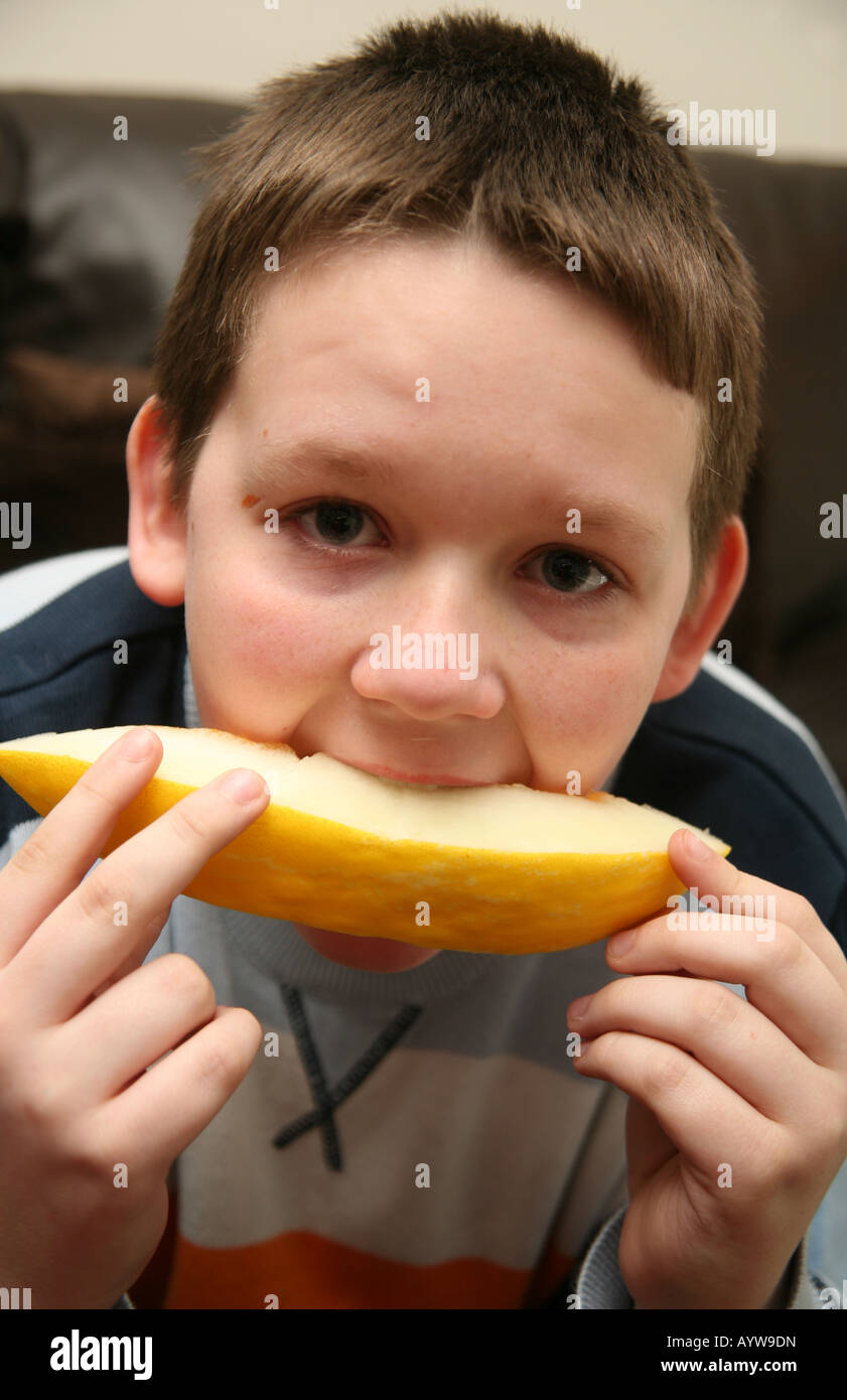 Boy eating melon Stock Photo Alamy