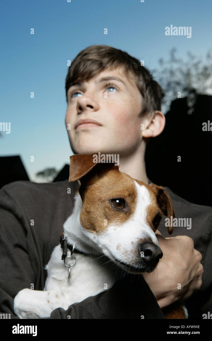 Boy holding an inquisitive jack russell dog Stock Photo