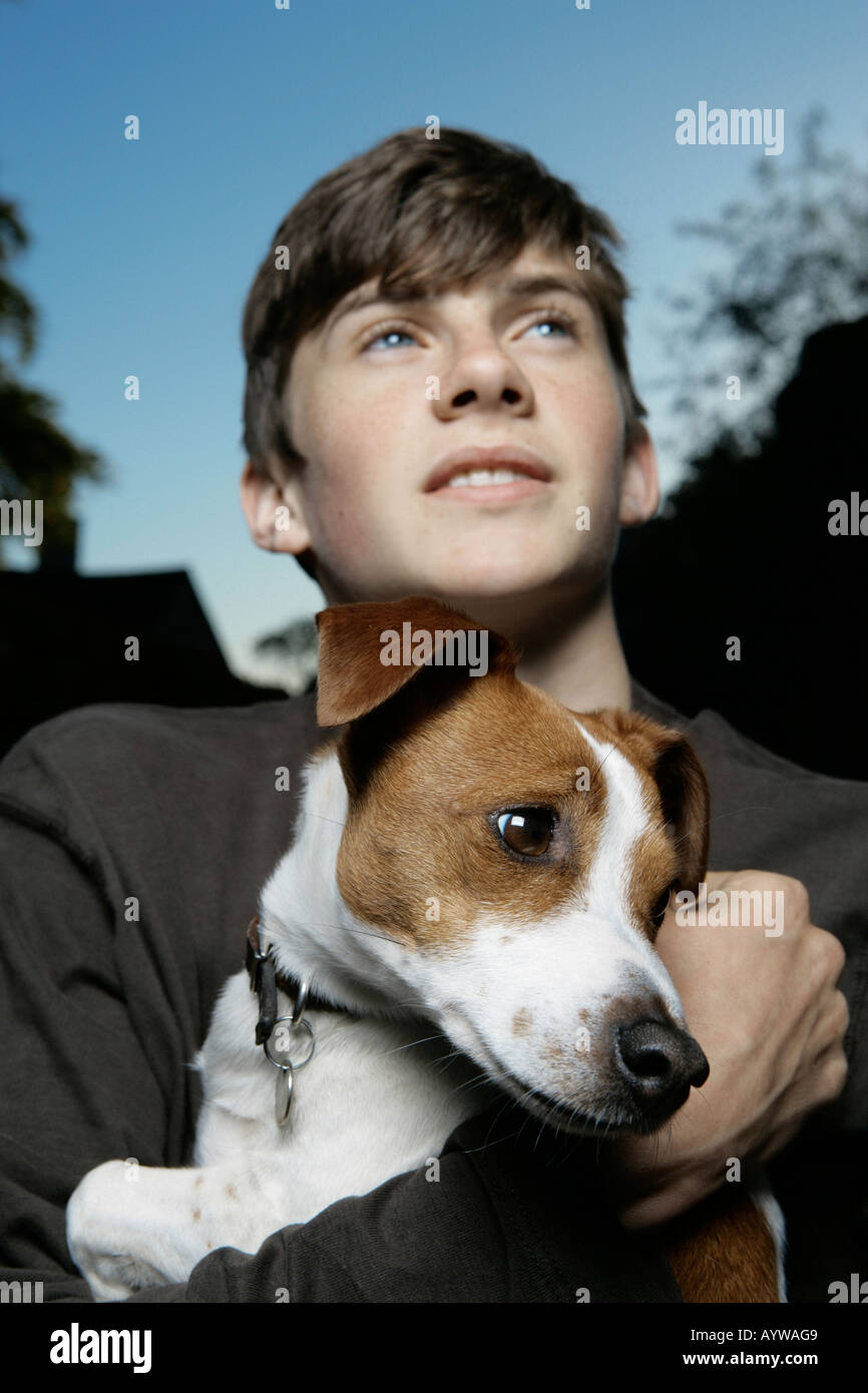 Boy holding an inquisitive jack russell dog Stock Photo