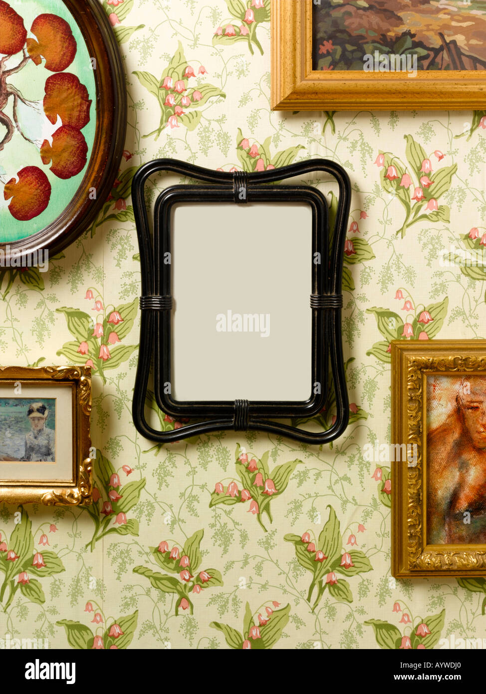 A blank frame hanging on a kitsch wall surrounded by other pictures Stock Photo Alamy