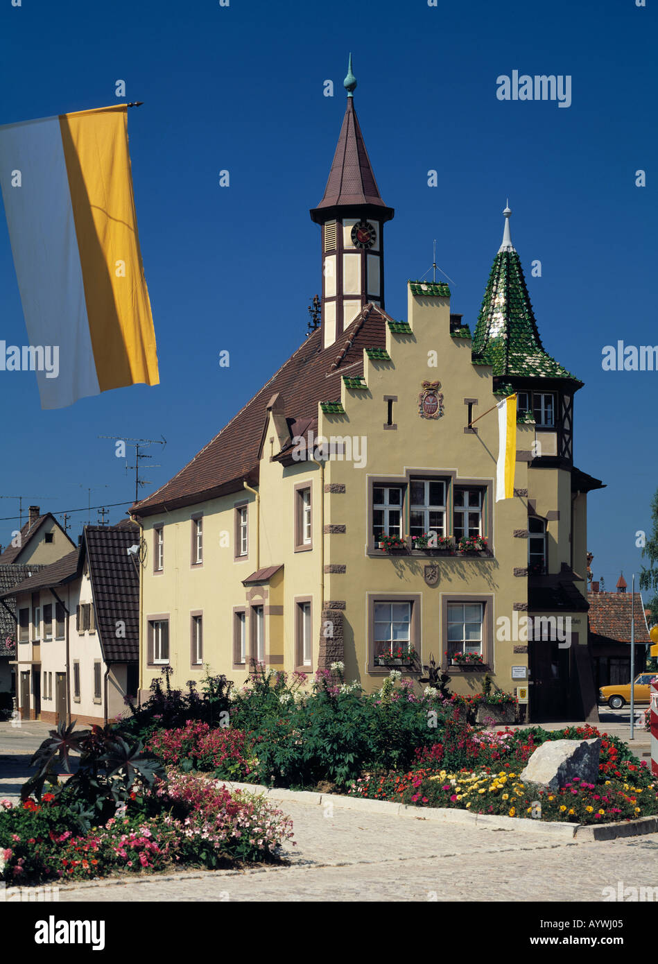Rathaus mit Ziertuermen und Stufengiebel, Flagge, Blumenbeete, Heitersheim, Markgraefler Land, Baden-Wuerttemberg Stock Photo