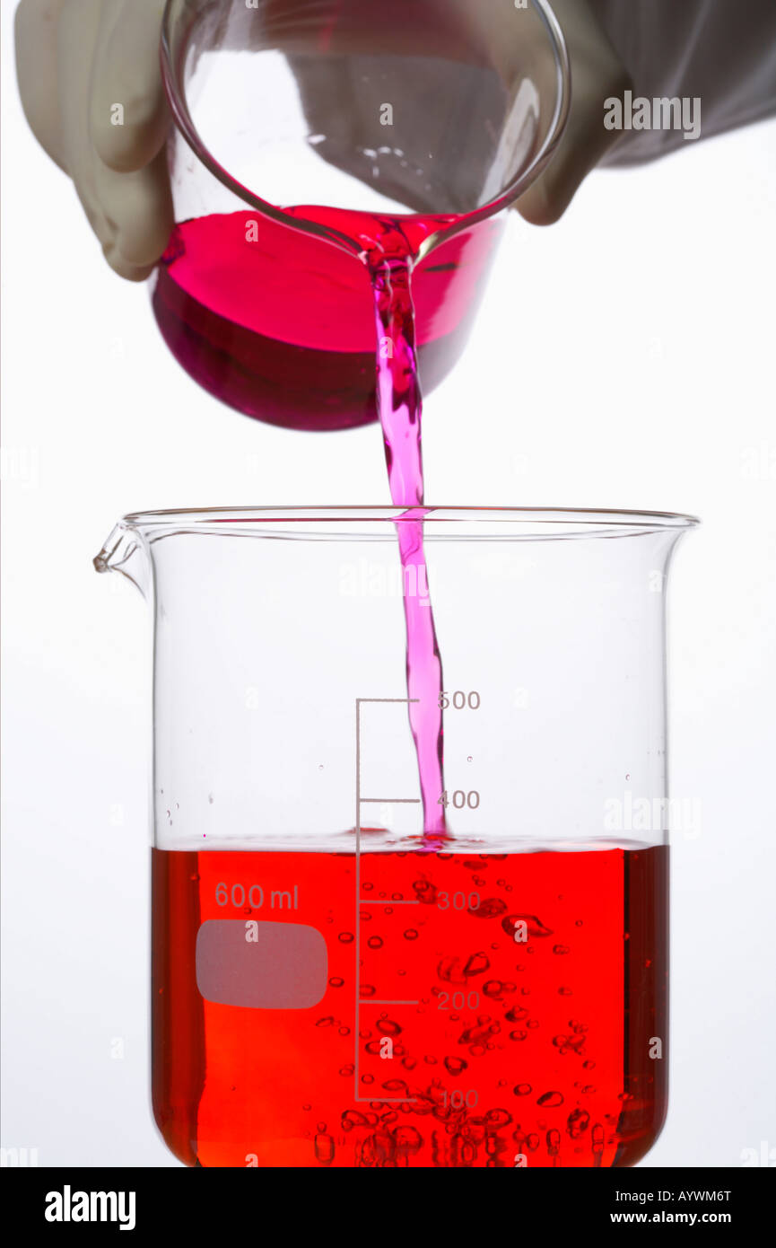 Pouring of red liquid into a beaker hires stock photography and images