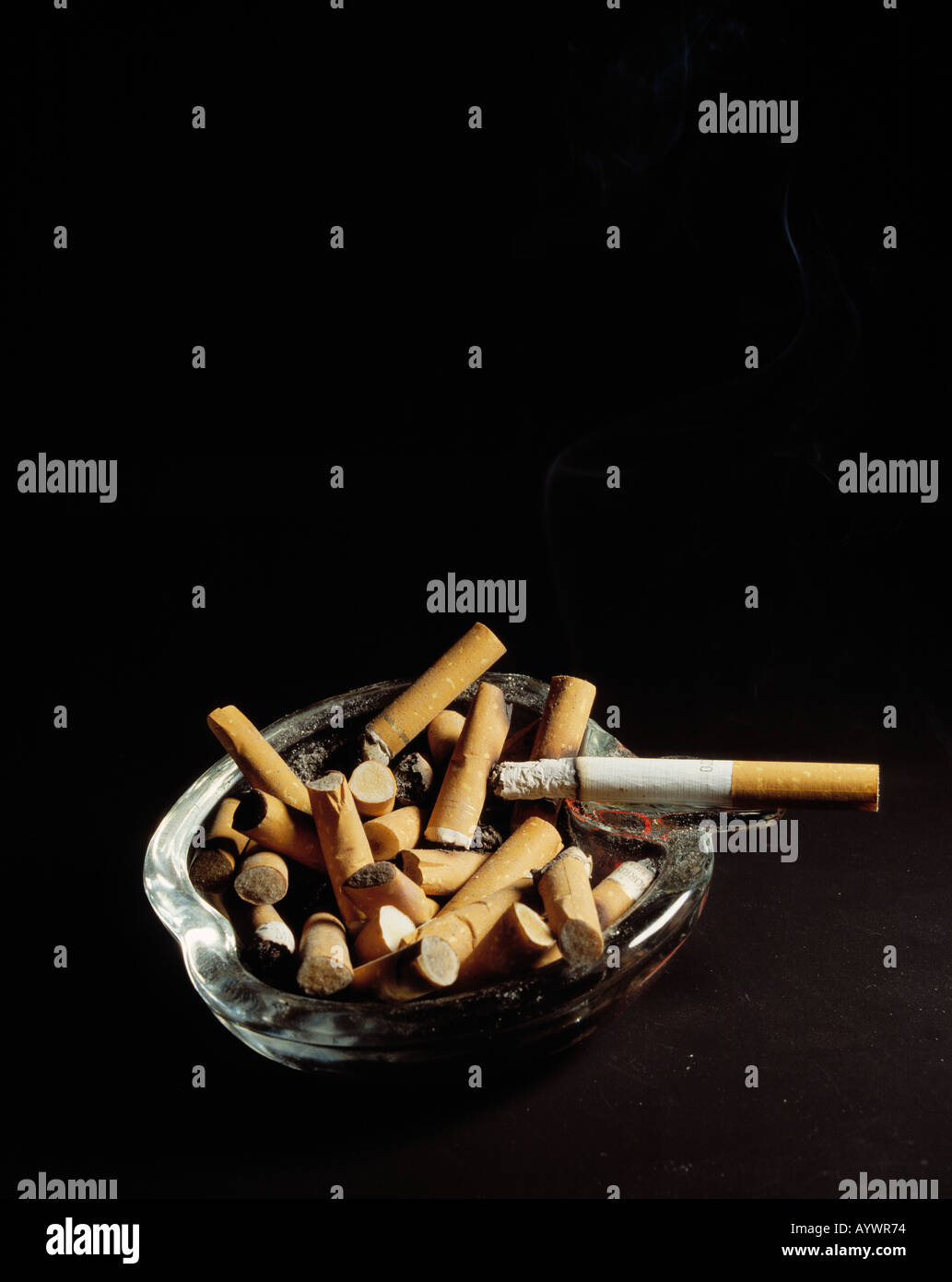 health, full ashtray, overcrowded, smoking cigarette on the ashtray, cigarette ends, butts, stubs, smoking Stock Photo