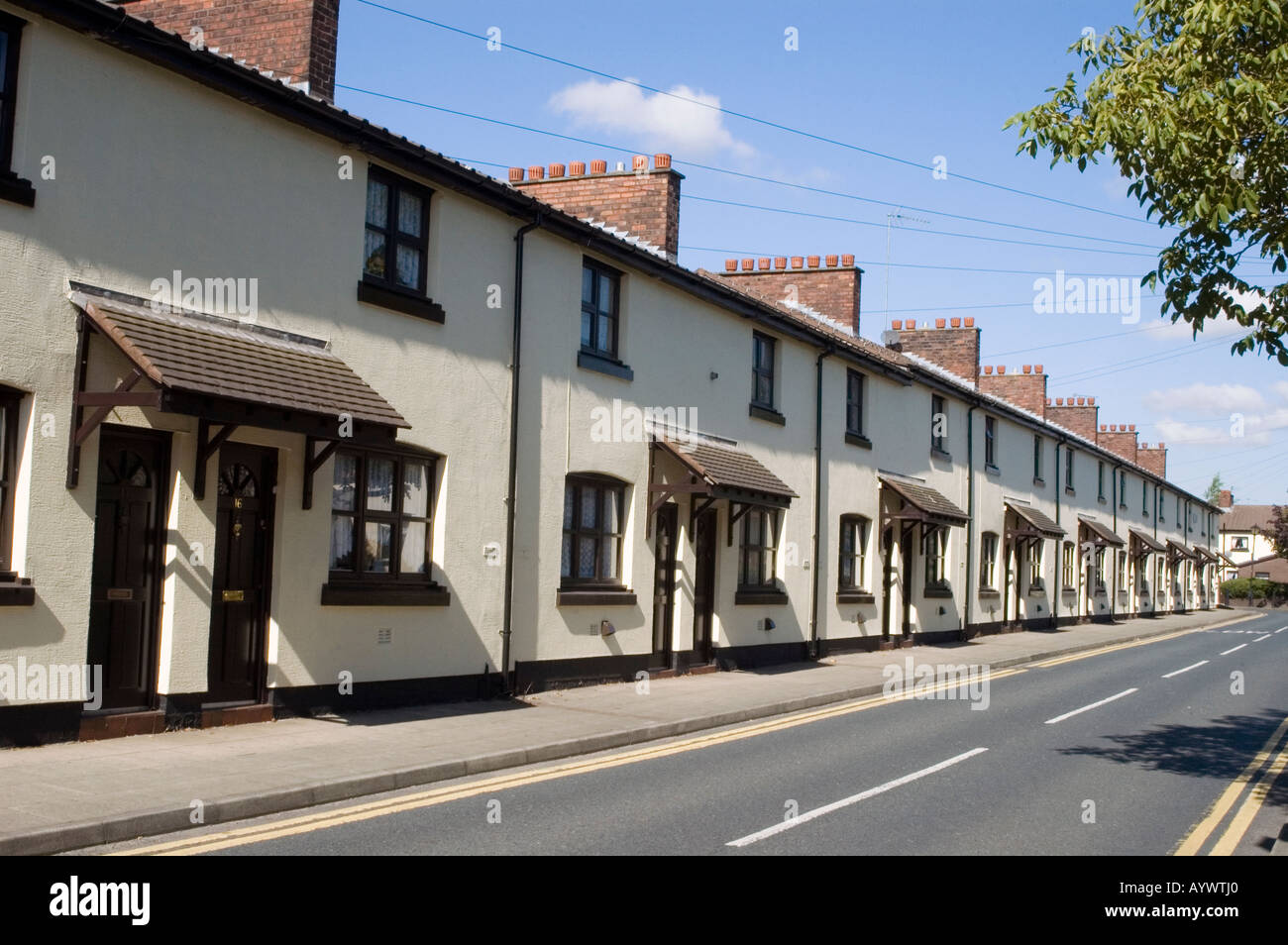 Row of houses built for local workers at engineering factory england uk Stock Photo
