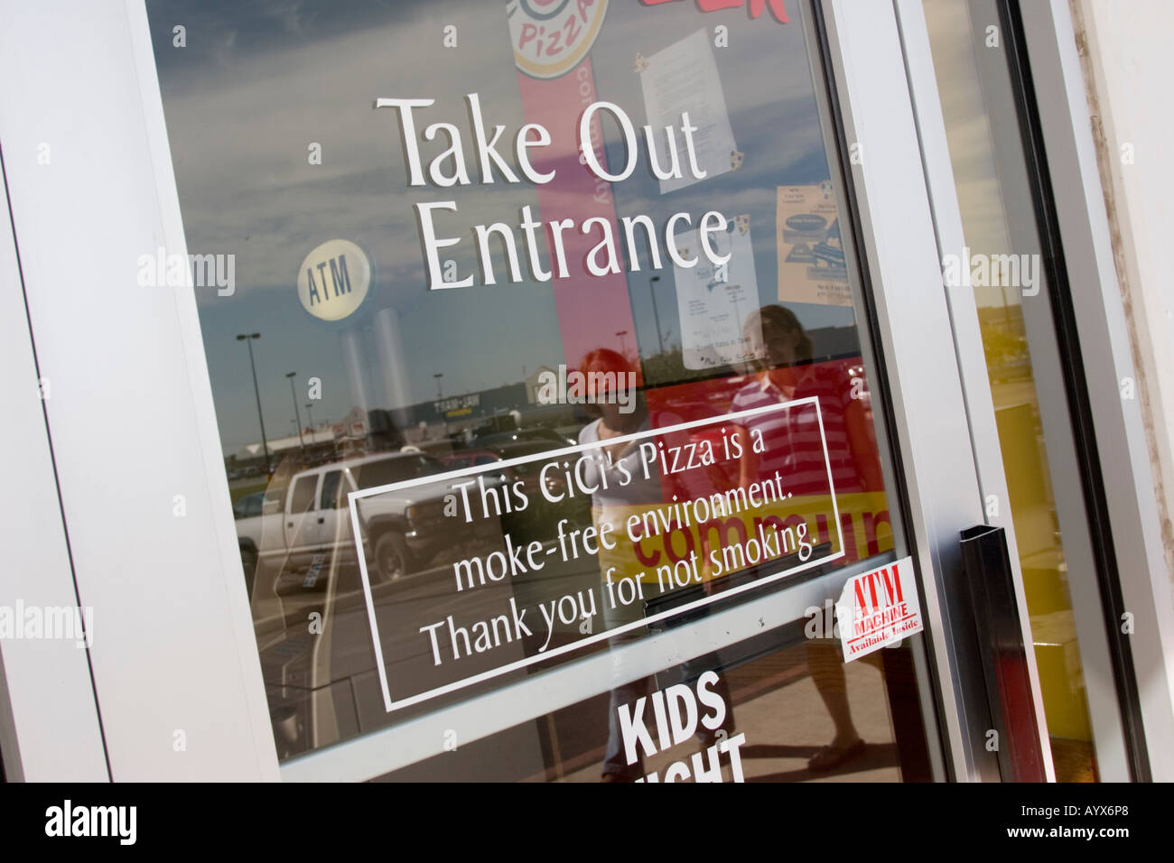 Take out entrance and CiCi's Pizza is a smoke free environment sign on