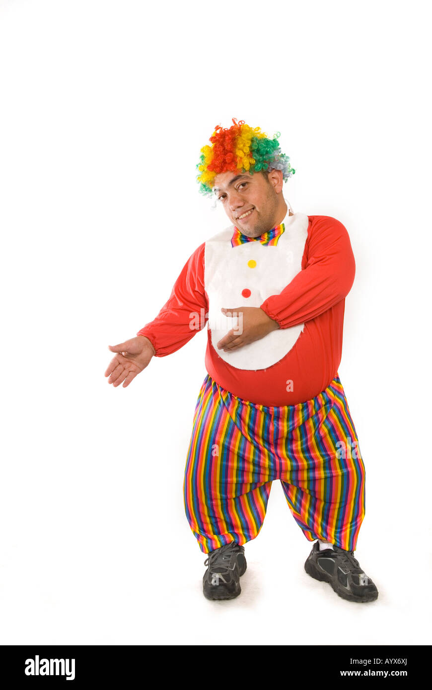 Full length portrait of a midget clown pointing hands against a white background Stock Photo