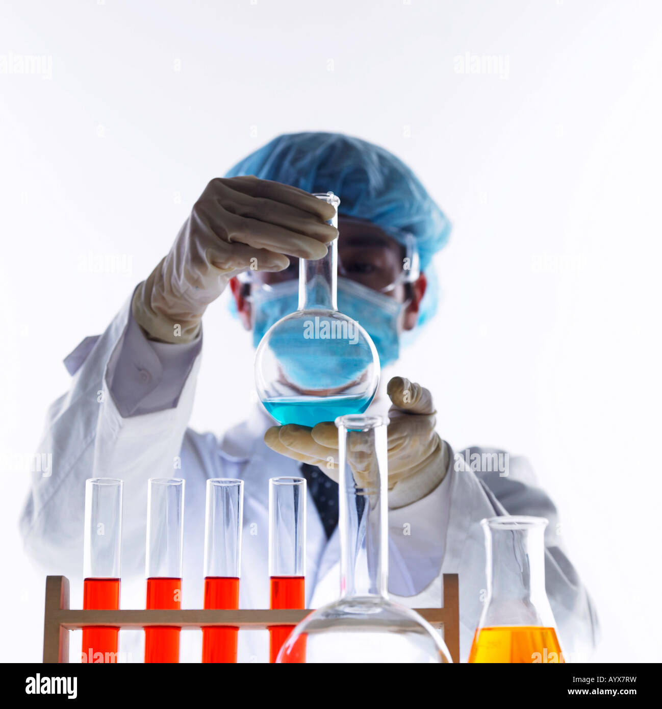 man doing experiment with various fluid Stock Photo - Alamy