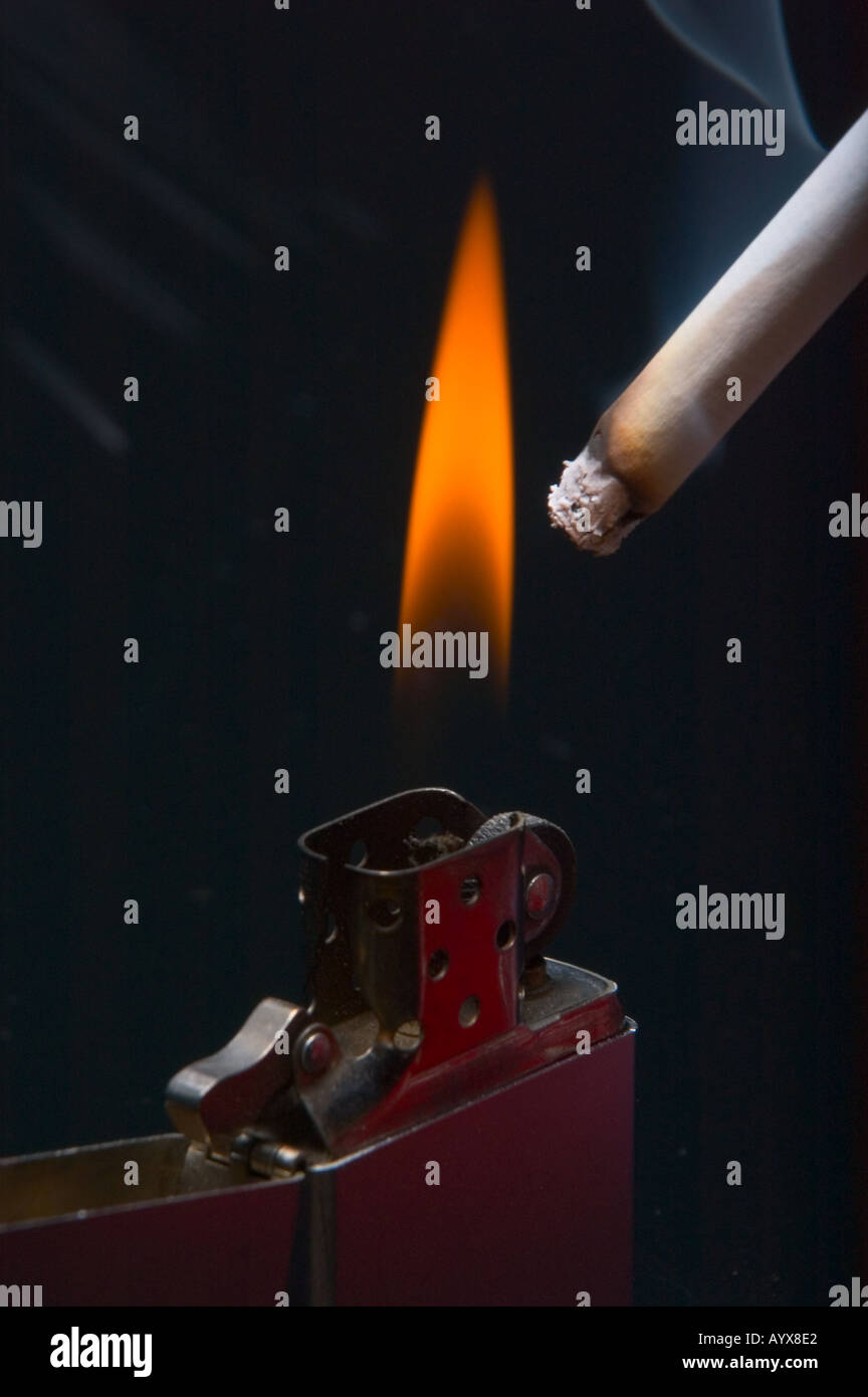 Cigarette lighter with flame lighting cigarette Stock Photo Alamy
