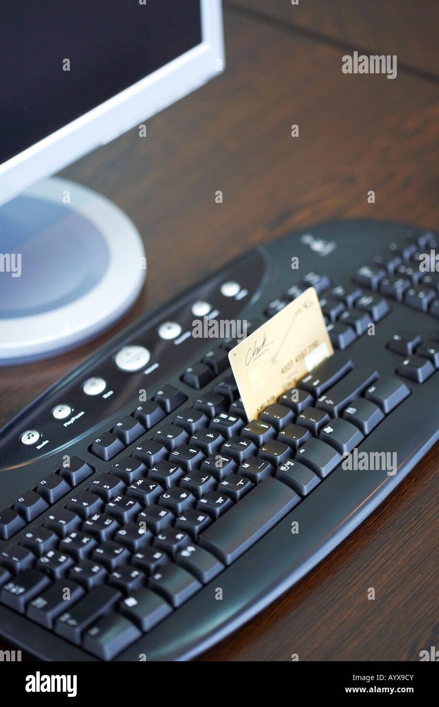 credit card sitcked at keyboard Stock Photo Alamy