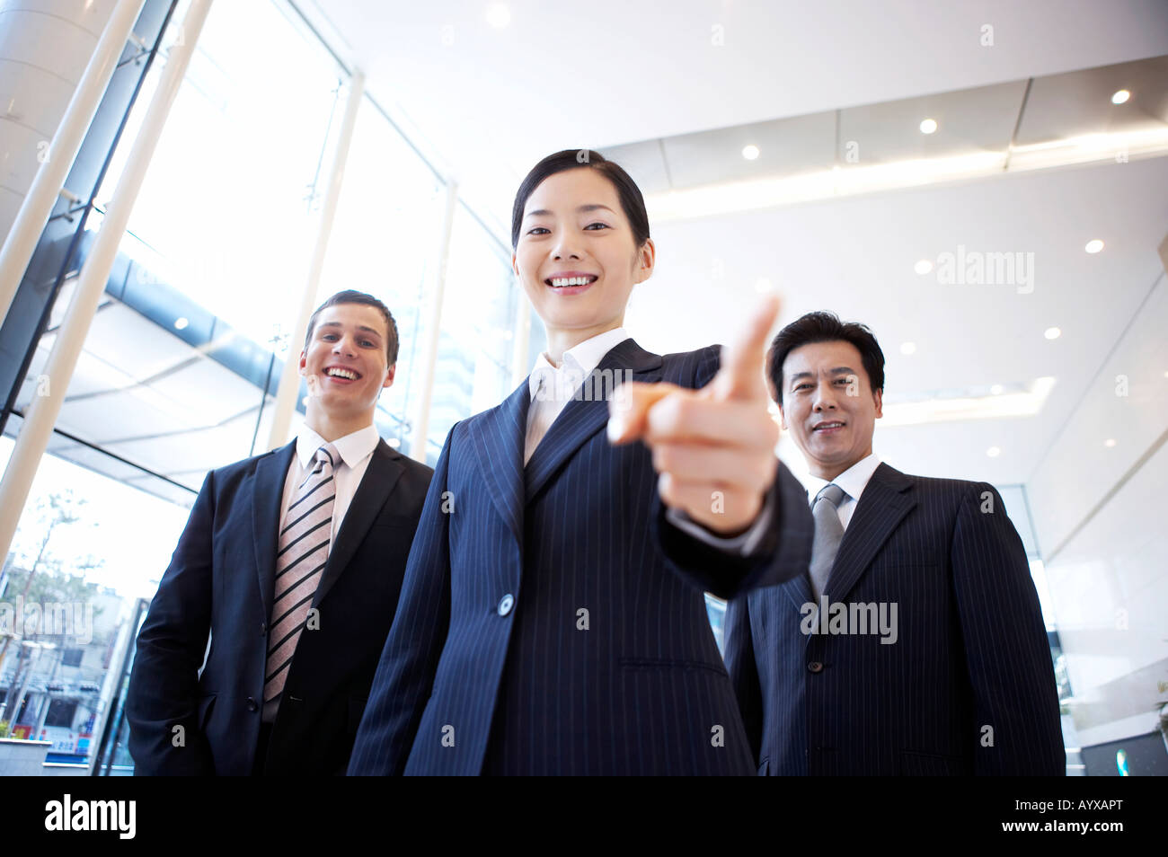 smiling man and woman pointing at each other Stock Photo - Alamy