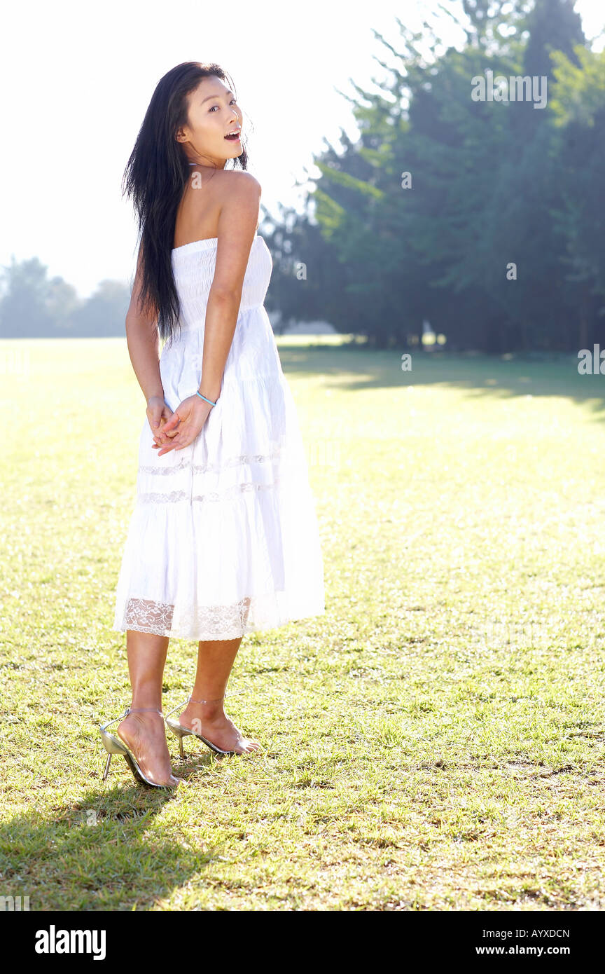 Full length portrait of a cute smiling girl in pink one piece dress,  wearing blue aviator sunglasses, posing on a forest path / nature  background Stock Photo - Alamy