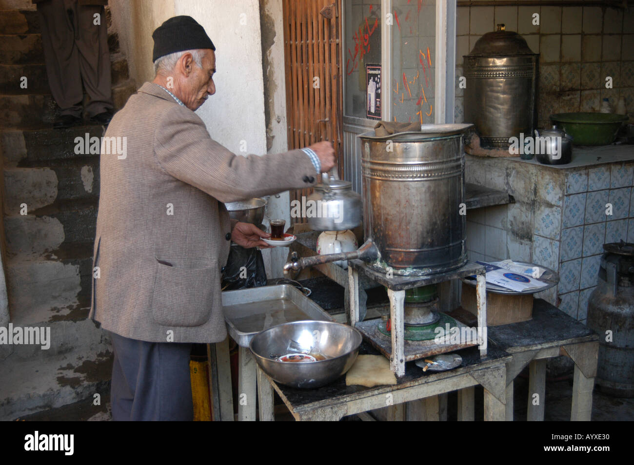 Iraqi tea shop owner pouring tea to serve to patrons Al Rashid Street Baghdad Iraq Stock Photo
