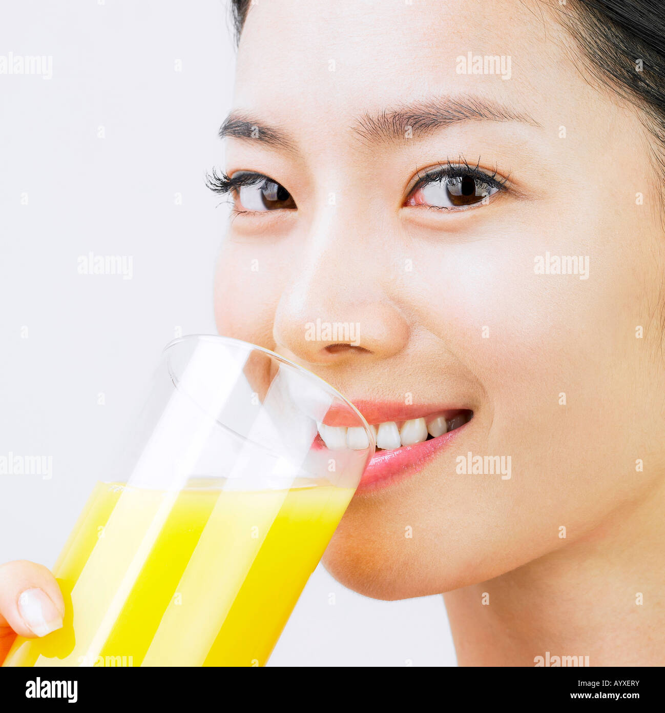 a woman's face drinking juice Stock Photo Alamy