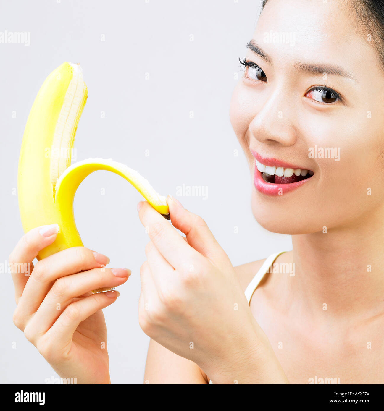 a woman peeling a banana Stock Photo Alamy