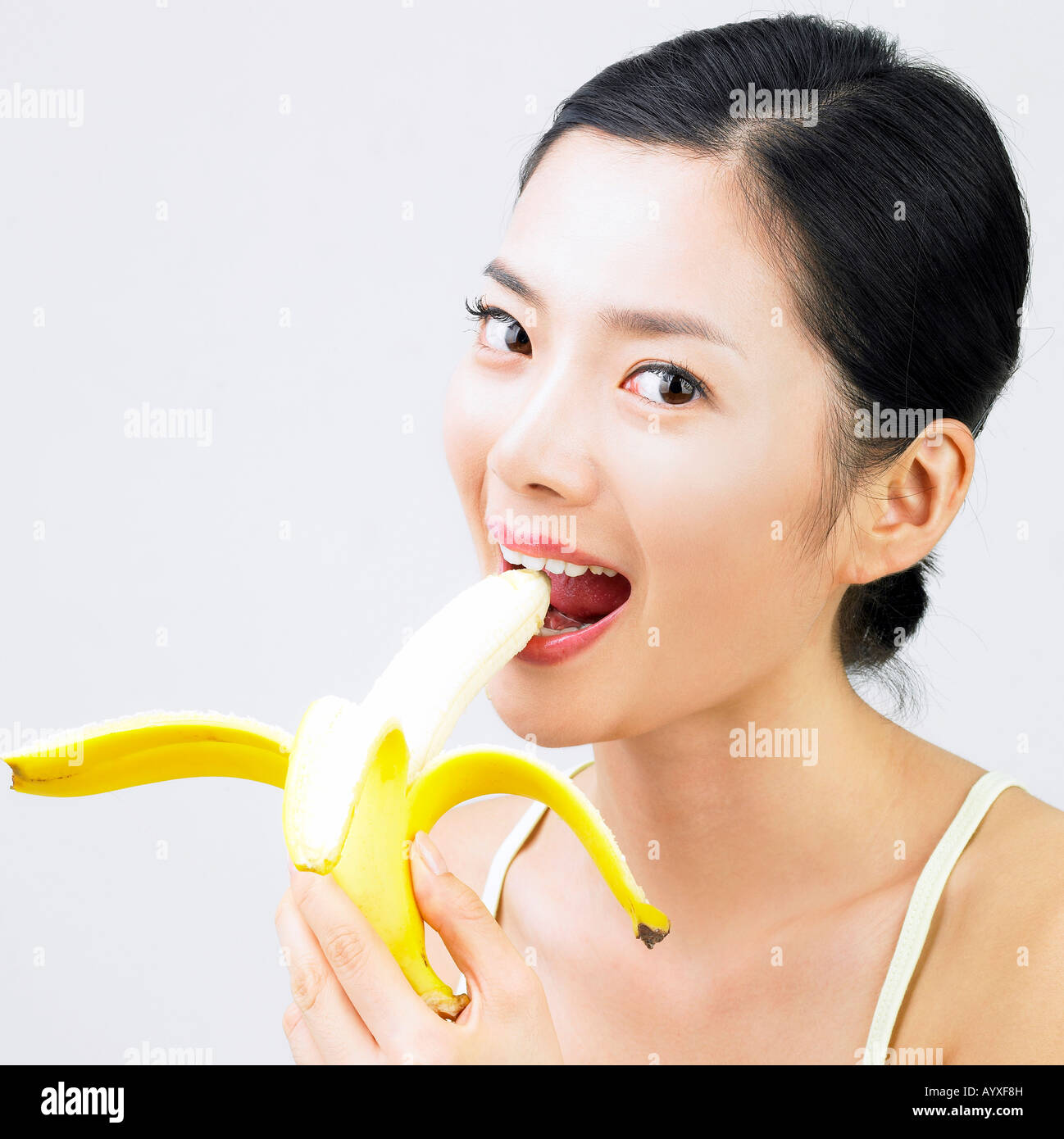 a woman eating a banana Stock Photo Alamy