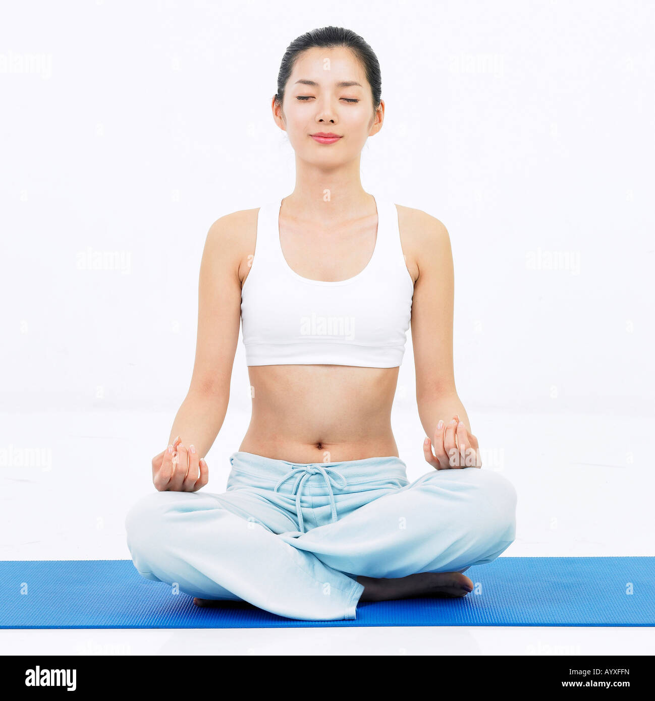 a woman mediating with sitting on and closing eyes Stock Photo - Alamy